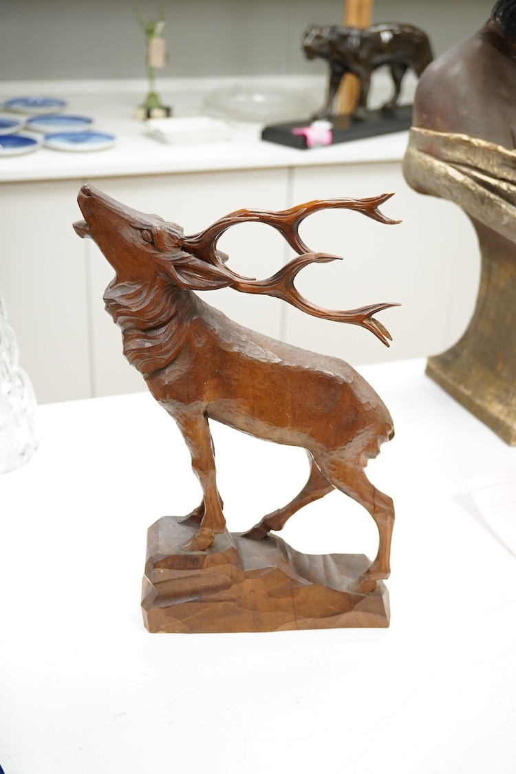 A Swiss Black Forest carving of a roaring stag, 34cm high